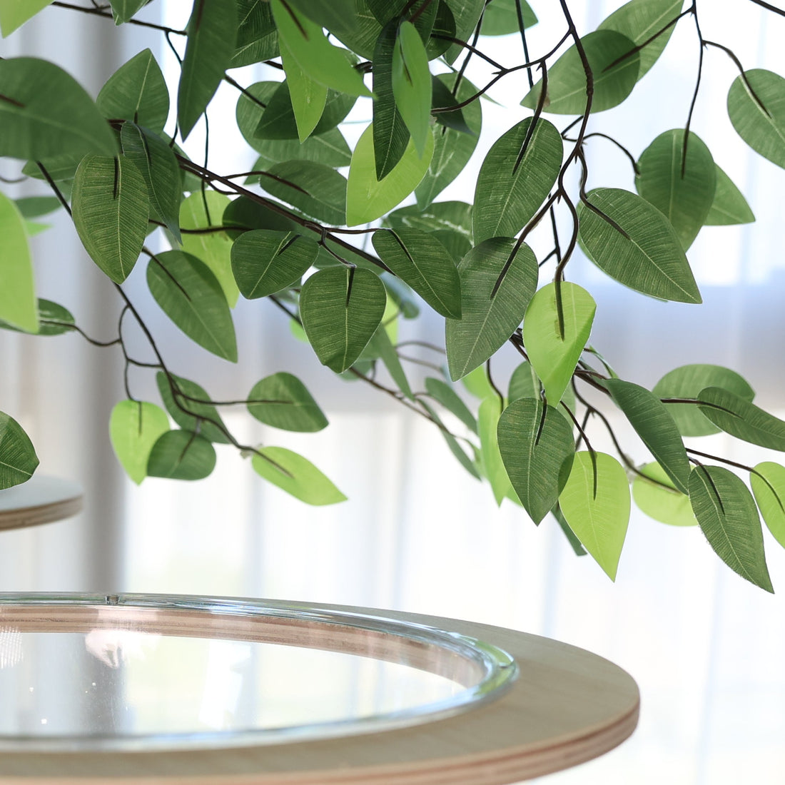 Artificial leafy canopy providing elevated shelter for indoor cats.